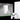 White gaming console and controller with Xbox branding on a black background